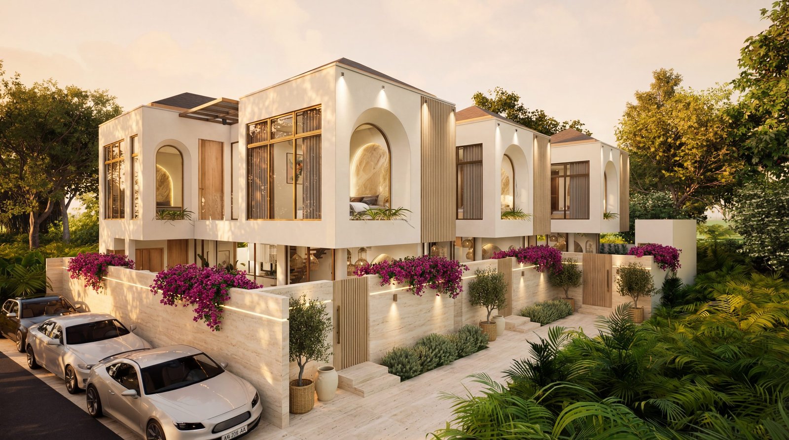 Row of three private Nirvana villas at golden hour with travertine walls, bougainvillea and tropical landscaping